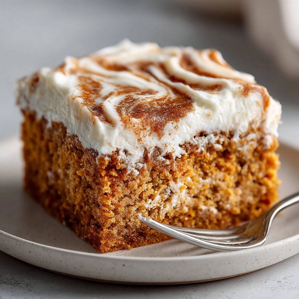 Warm, moist Chaos Cake is pictured, adorned with a cinnamon swirl inviting the taste buds.