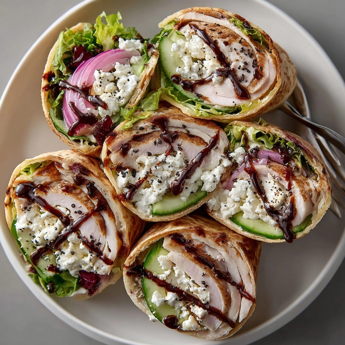 A close-up shot of delicious cherry balsamic glazed turkey wraps, piled high, ready to eat.