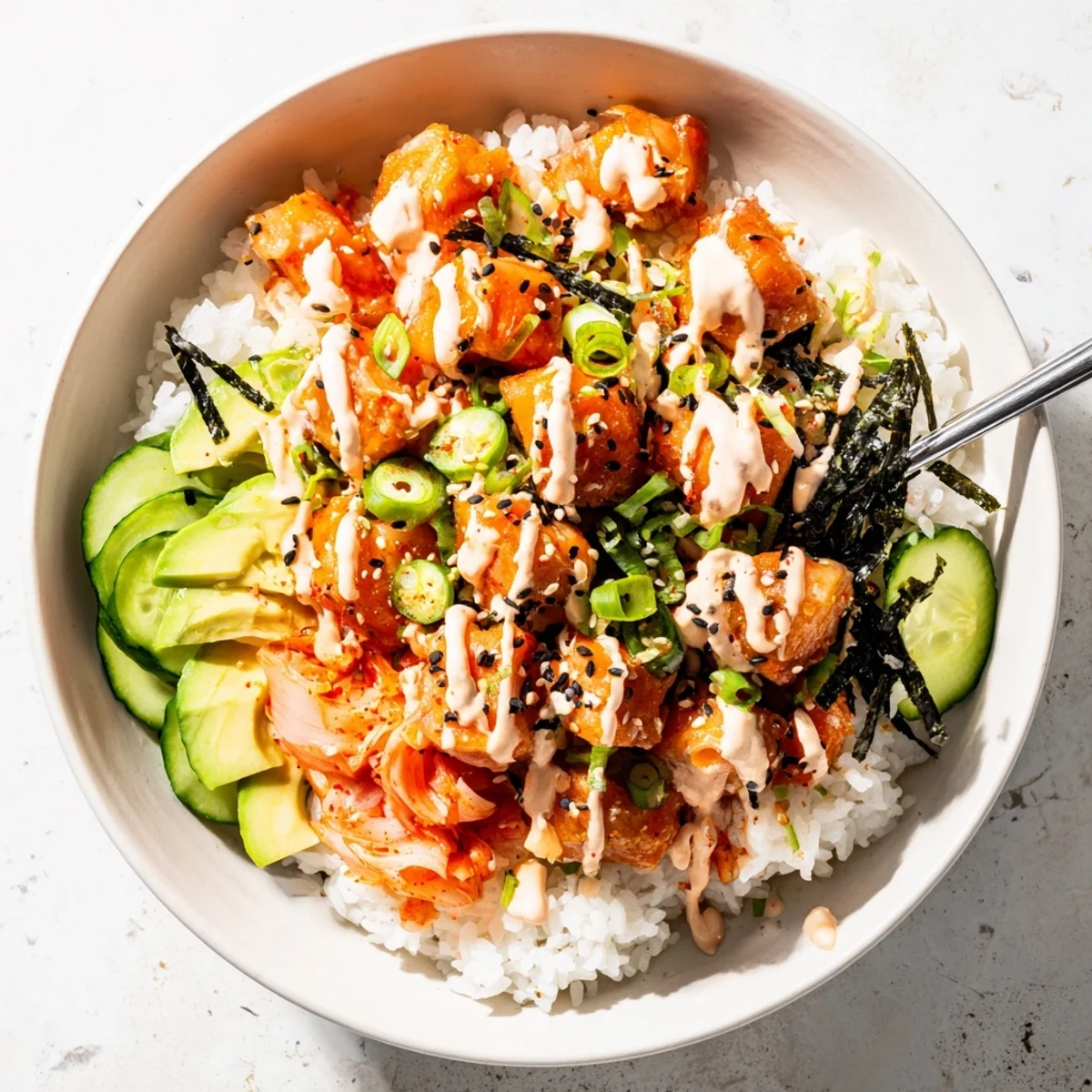 Crispy Salmon Rice Bowl topped with vibrant kimchi, creamy avocado, and spicy mayo.  