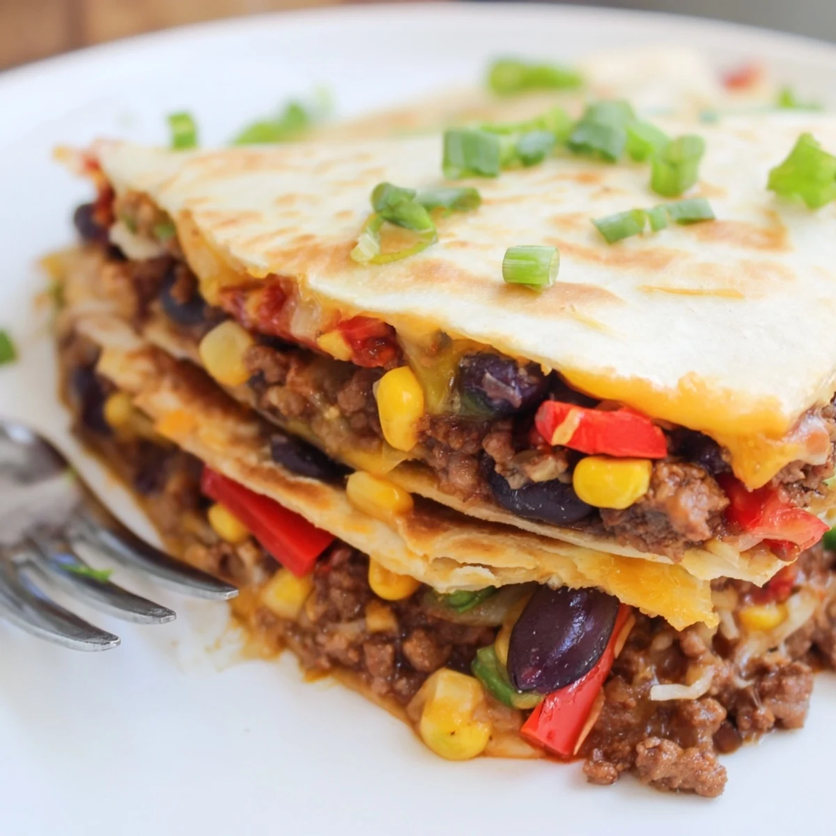 Crispy Sheet Pan Quesadillas with Beef, filled with cheese and vibrant veggies.  