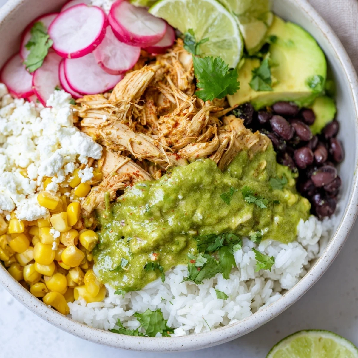 A delicious Green Enchiladas Rice Bowl topped with fresh ingredients and zesty sauce.  