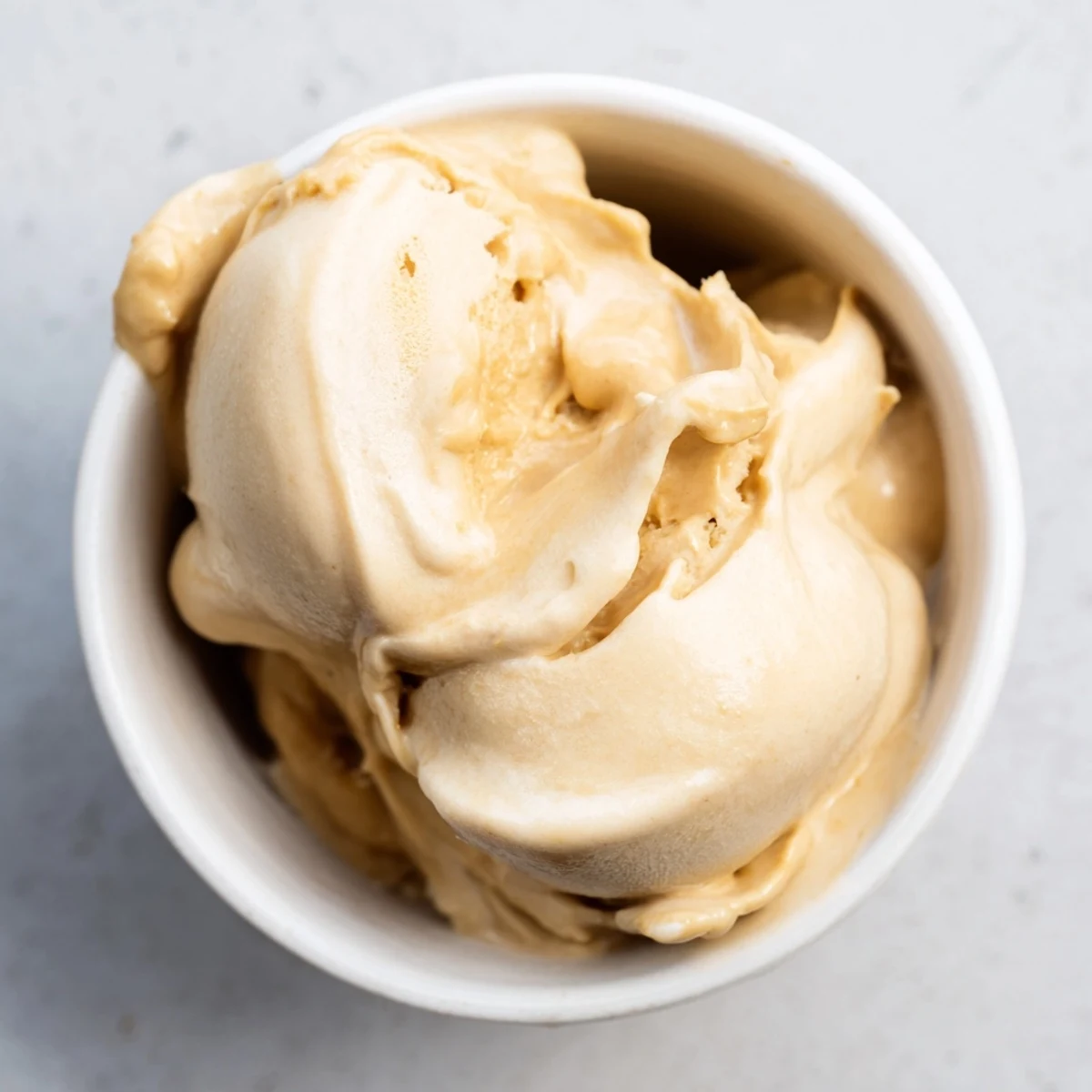 Creamy, homemade Peanut Butter Banana Ice Cream swirled with peanut butter, ready to enjoy.