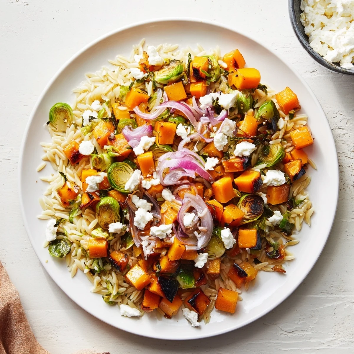 Vibrant Best Fall Harvest Orzo Salad with roasted butternut squash and creamy goat cheese, ready for serving.