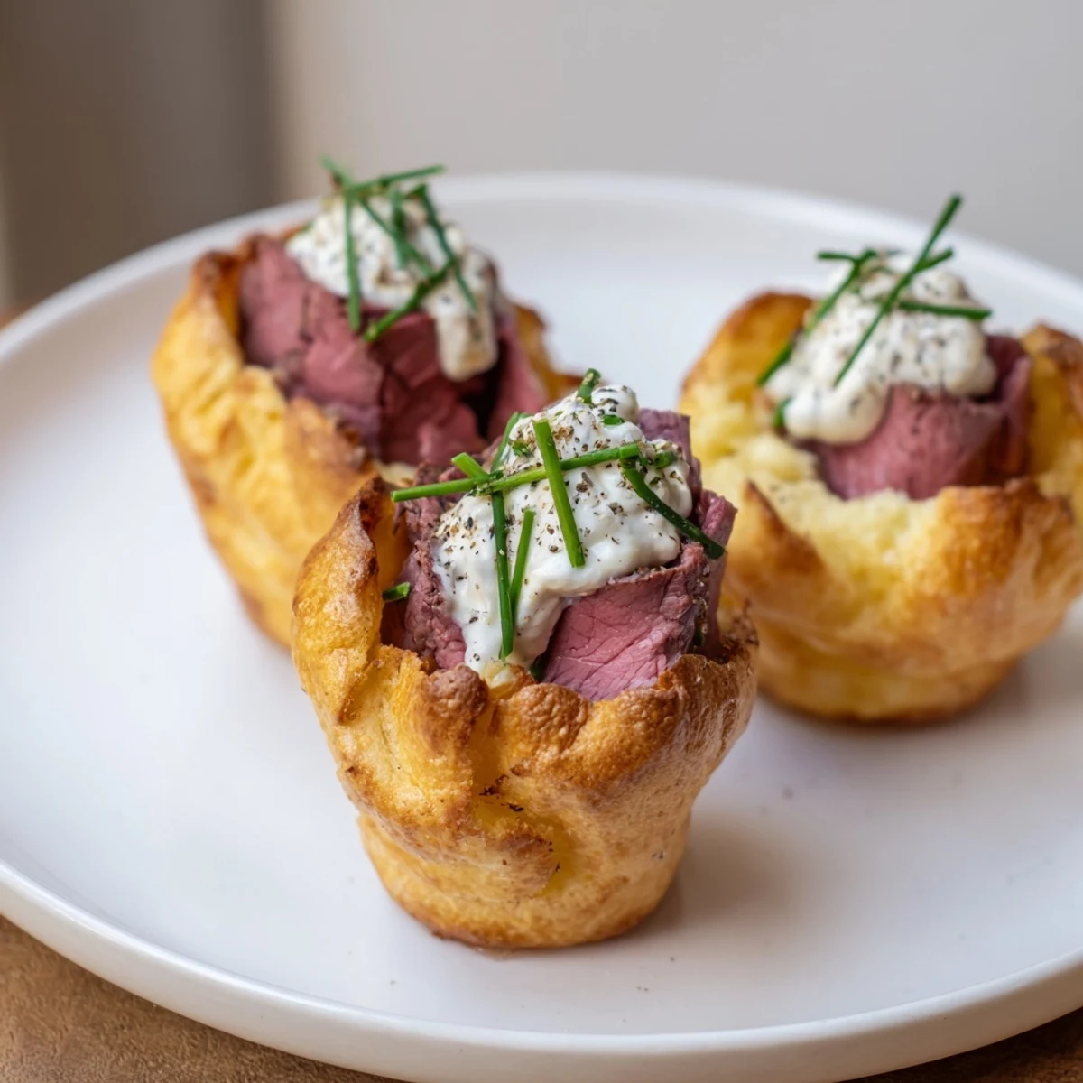 Golden, crispy Express Holiday Yorkshire Pudding Bites filled with beef and creamy horseradish, perfect for any holiday party.