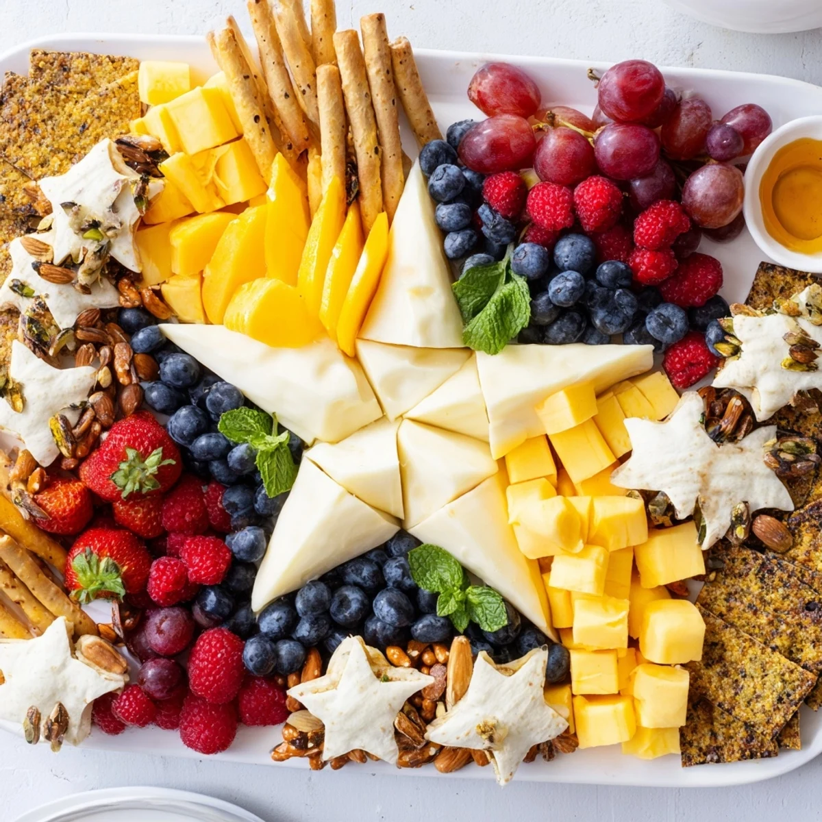 Festive Shooting Star Snack Board features colorful fruits, cheeses, crackers, and sweet treats ready to enjoy.