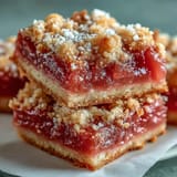 Golden-baked Guava Cake Bars with a tender crumb and vibrant pink guava filling, resting on parchment.