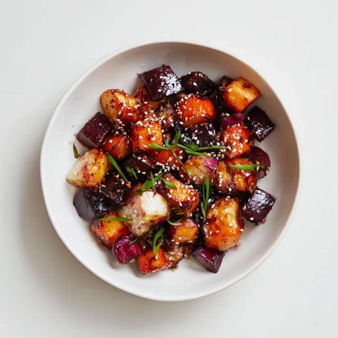 Roasted miso winter vegetables, glistening with glaze, ready to serve with toasted sesame seeds and green onions.