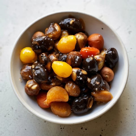 Delectable Squirrels Gourmet Nut Bowl, offering a mix of golden, roasted nuts alongside bright red cranberries.