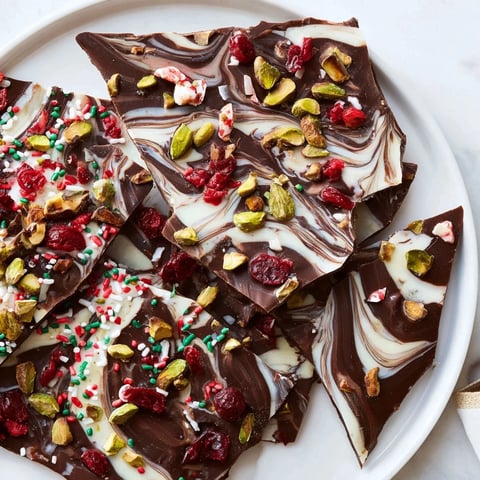 Beautiful shards of Holiday Bark, a colorful chocolate dessert, ready for gifting or enjoying.