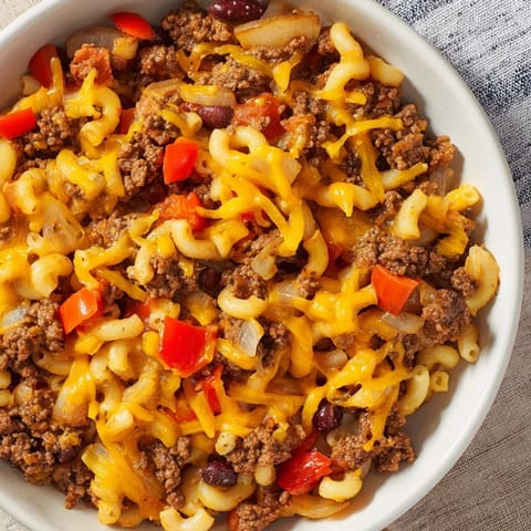 A close-up of creamy, cheesy Cheeseburger Chili Mac Skillet, a budget-friendly and delicious one-pan meal.