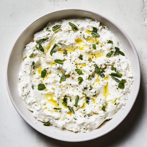 Creamy whipped feta dip with refreshing lemon-mint, ready to scoop with crackers for guests.