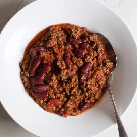Garnished The Secret 4-Ingredient Slow Cooker Chili, this easy chili simmers with rich flavors and aromas.