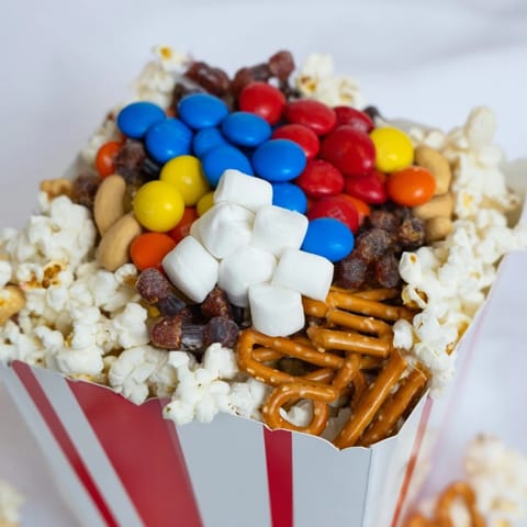 Beautifully arranged popcorn boxes overflowing with treats: a perfect movie night snack platter.