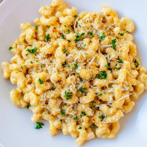 Golden-topped high-protein mac & cheese with parsley garnish, perfect for a cozy dinner.