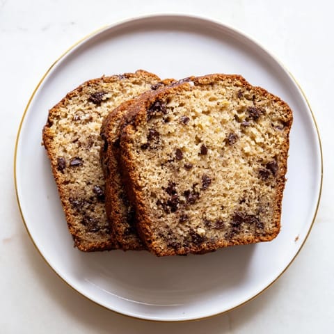 A warm, freshly baked loaf of Banana Bread, perfect for a cozy morning breakfast.