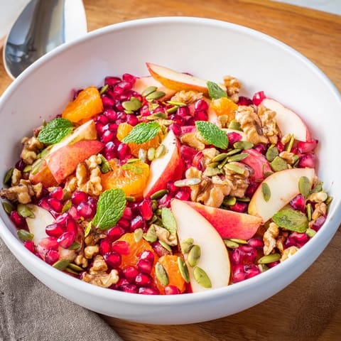 Bright red pomegranate seeds, crisp diced apples, and toasted walnuts tossed in a citrus dressing.