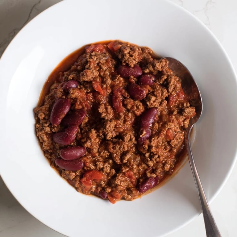 Garnished The Secret 4-Ingredient Slow Cooker Chili, this easy chili simmers with rich flavors and aromas.