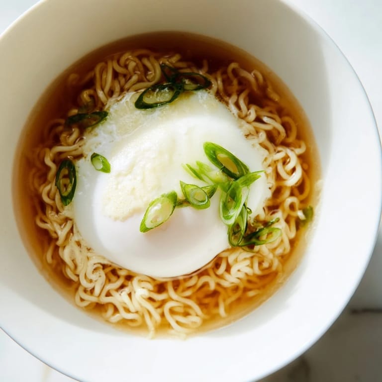Picture the golden yolk atop this Upgrade Instant Ramen, swimming in a rich, buttery broth.