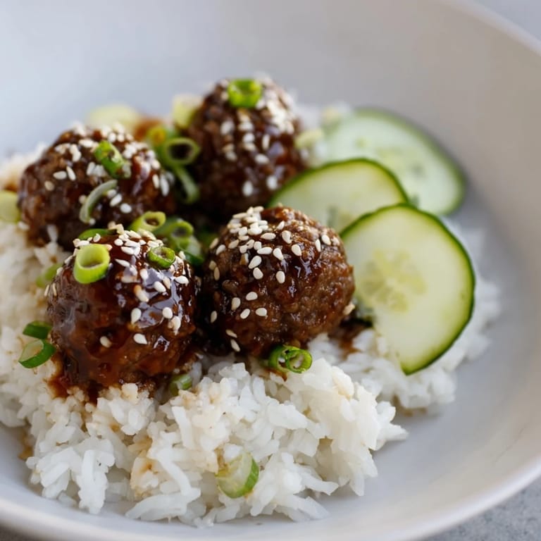 Flavorful teriyaki meatball bowls featuring savory meatballs in a rich sauce, ready to be served and devoured.