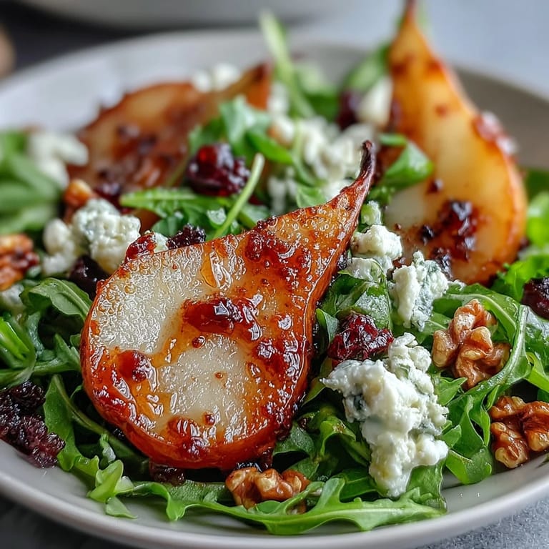 Crisp Pear Gorgonzola Salad with crunchy walnuts and creamy Gorgonzola, drizzled.