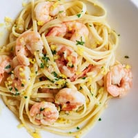 Plump, pink shrimp nestled in glossy strands of Garlic Butter Shrimp Linguine, garnished with fresh parsley.